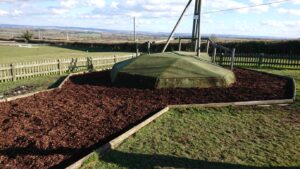 A restored play area in Garsington Oxford with repaired timber edgings