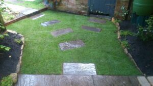A new walkway with sunken stepping stones in to the new lawn