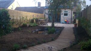 New garden under construction with an oak decking pathway