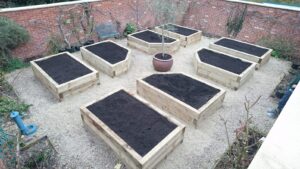 New raised beds set within a lovely walled garden filled with planting compost
