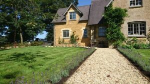 Creating a long lavender hedge in Little Tew running along the pathway