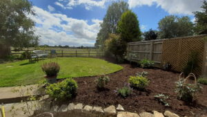 We extended the lawn onto over four tonnes of topsoil to raise the level and topdressed the borders with compost. Shipton under Wychwood.